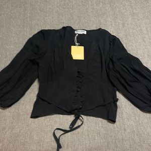Charlie Holiday black cropped blouse. Bottom down and ties at the waist.
